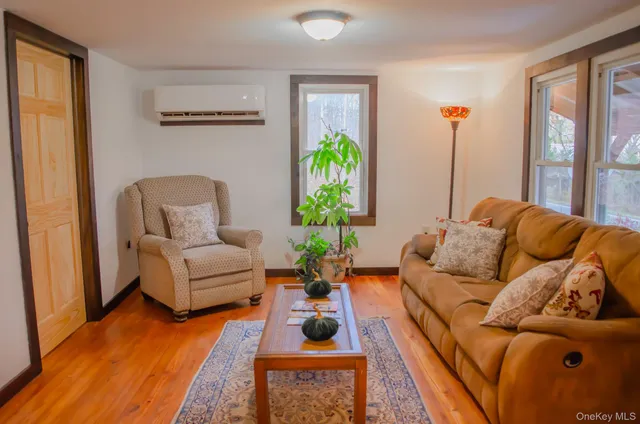 a living room with furniture fireplace and a large window