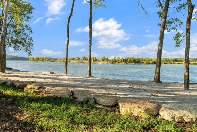 a view of house with yard and lake view