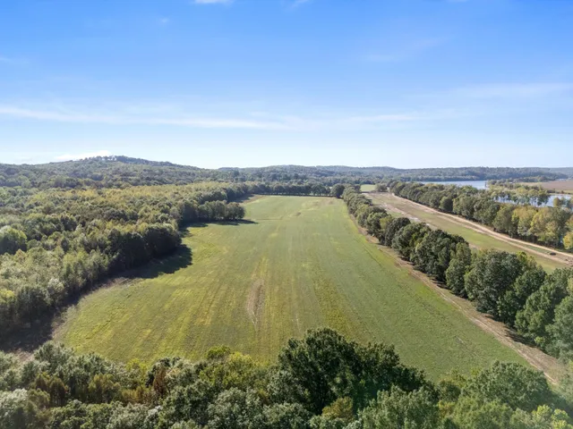 a view of a lake with houses in the back