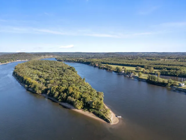 a front view of a building with sitting area and furniture