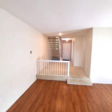 a view of a room with wooden floor