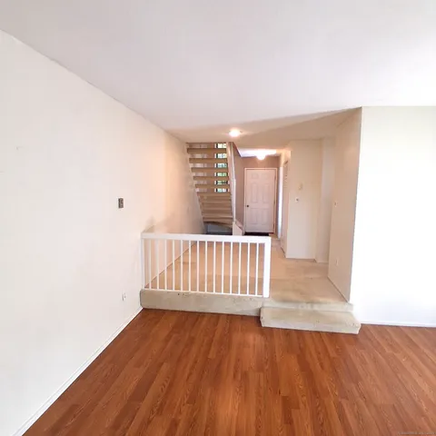 a view of a room with wooden floor