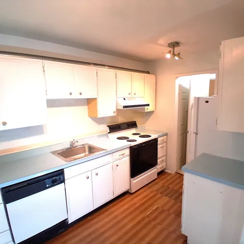 a kitchen with a sink stove and cabinets