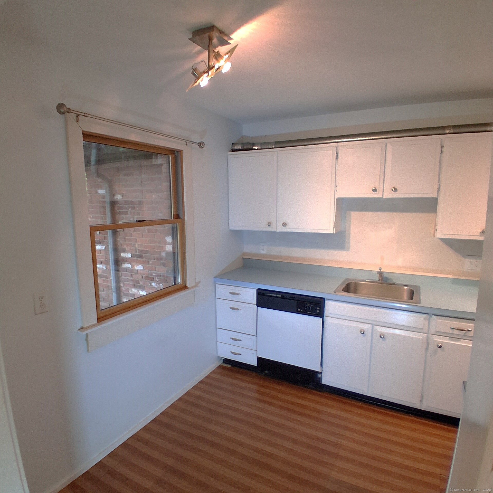 85 River Road, Unit B7 Essex, CT 06426 - Photo 10 of 23 a kitchen with granite countertop a stove a sink and cabinets