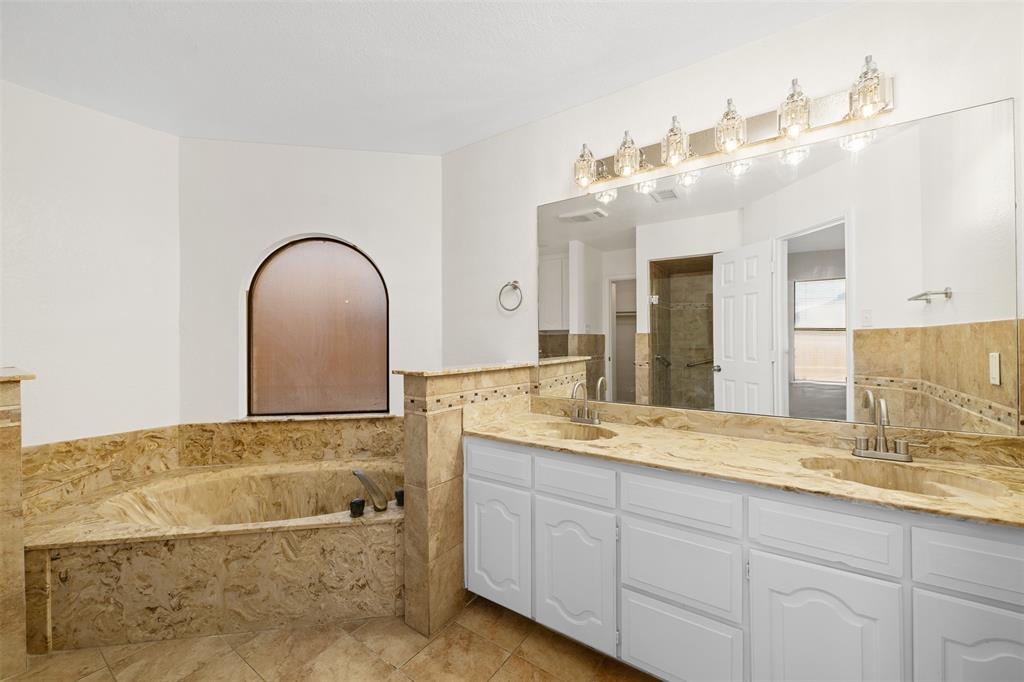 720 Sandy Trail Fort Worth, TX 76120 - Photo 13 of 24 a bathroom with a sink and a mirror