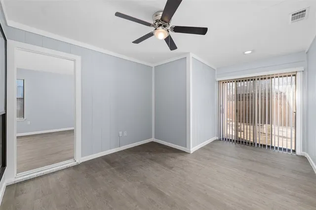 a view of an empty room with a fan