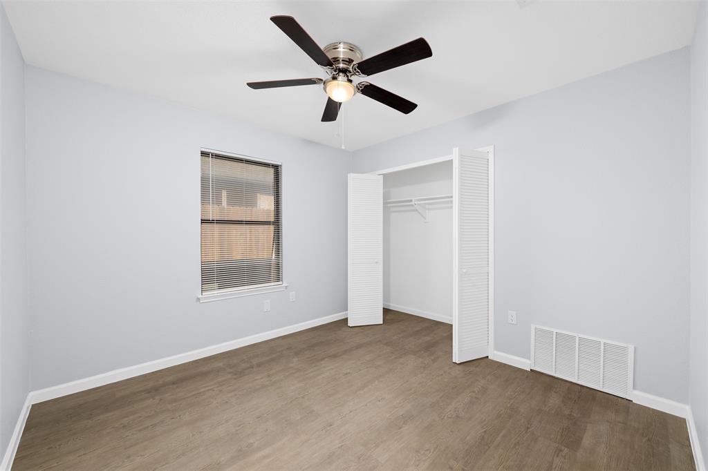 720 Sandy Trail Fort Worth, TX 76120 - Photo 20 of 24 an empty room with ceiling fan and windows