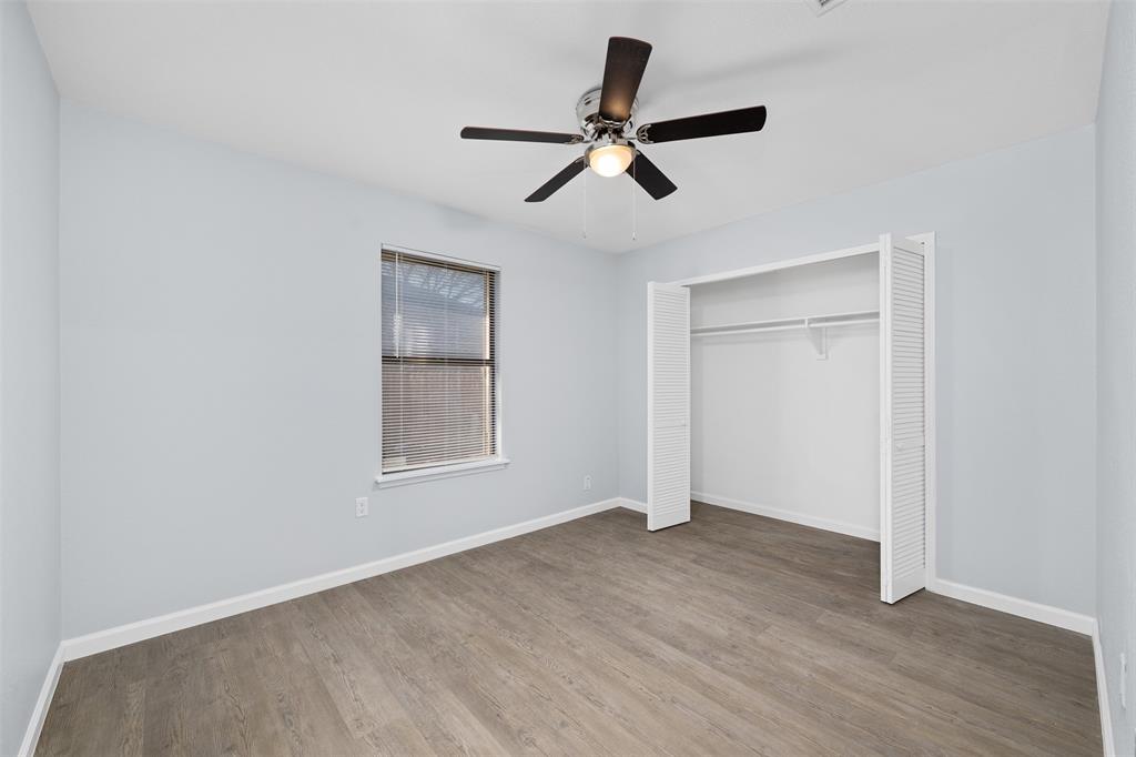 720 Sandy Trail Fort Worth, TX 76120 - Photo 20 of 26 a view of empty room with wooden floor and window