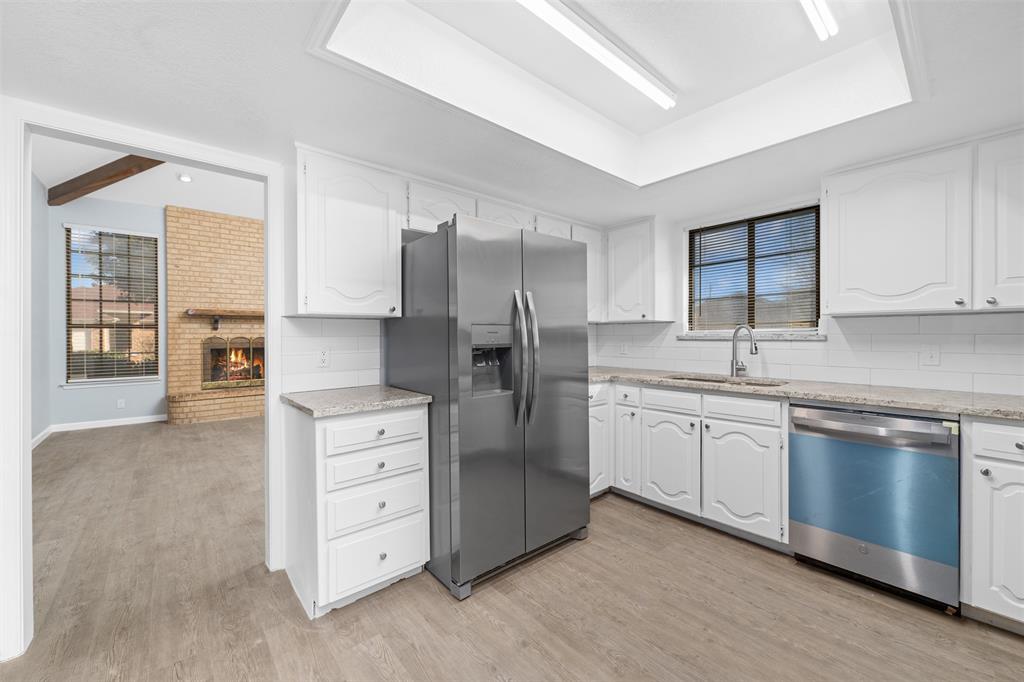720 Sandy Trail Fort Worth, TX 76120 - Photo 9 of 26 a kitchen with stainless steel appliances a refrigerator sink and cabinets