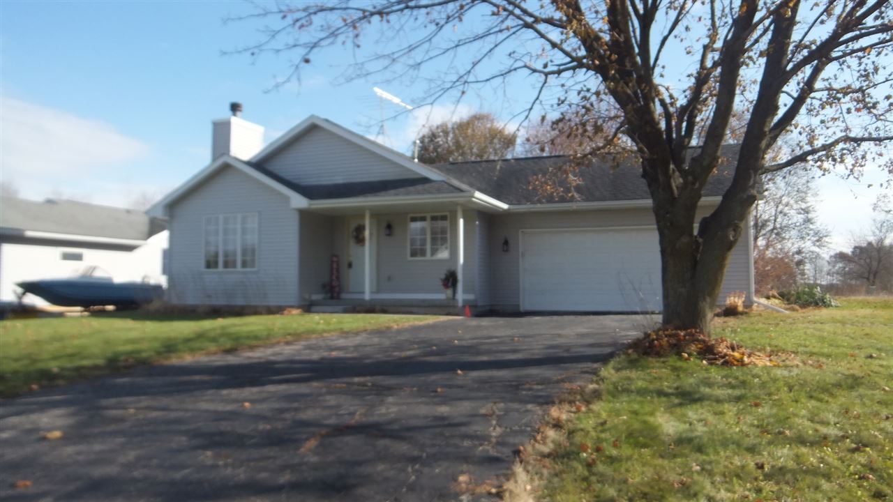 120 Minarette Drive Southwest Poplar Grove, IL 61065 - Photo 1 of 22 a front view of a house with a yard and garage