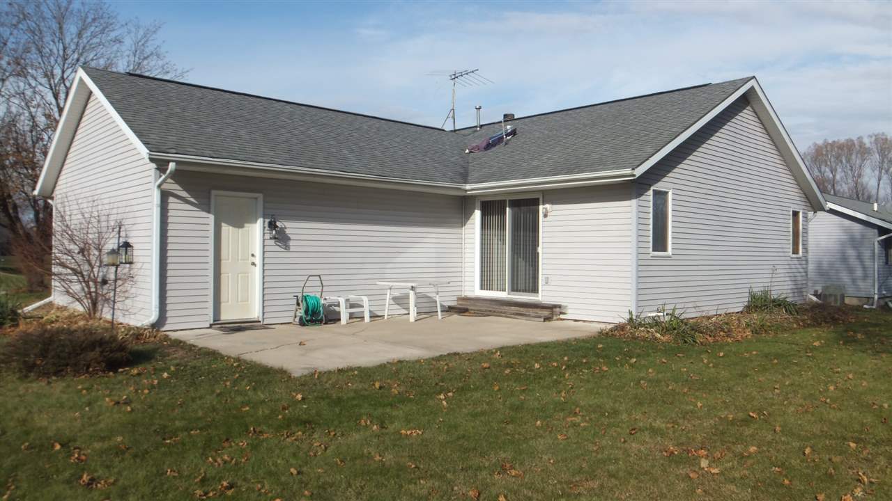 120 Minarette Drive Southwest Poplar Grove, IL 61065 - Photo 5 of 22 a backyard of a house with table and chairs
