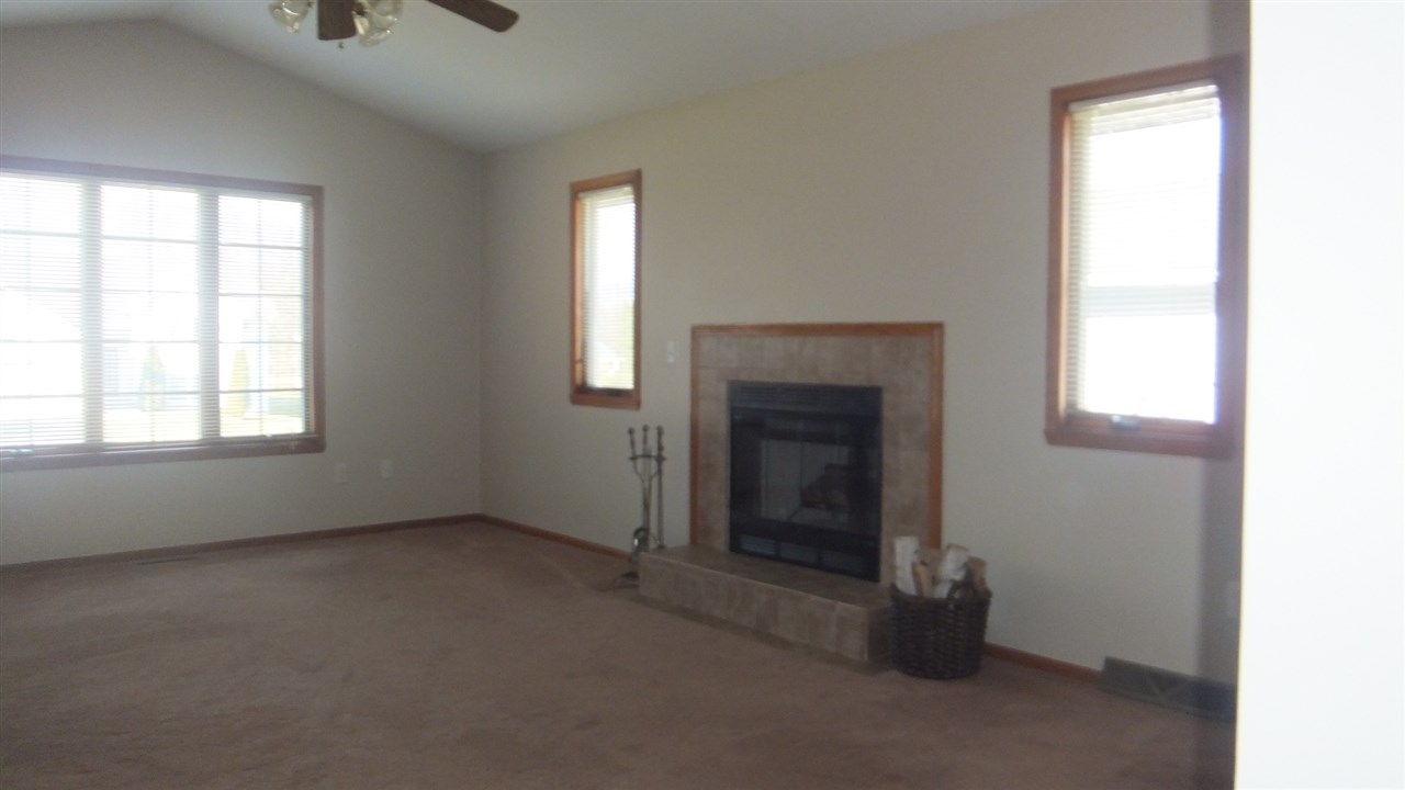 120 Minarette Drive Southwest Poplar Grove, IL 61065 - Photo 6 of 22 an empty room with windows and fireplace