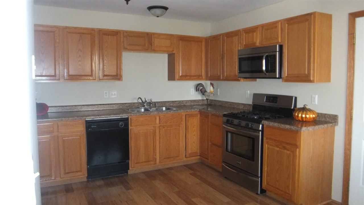 120 Minarette Drive Southwest Poplar Grove, IL 61065 - Photo 8 of 22 a kitchen with granite countertop a stove and a microwave