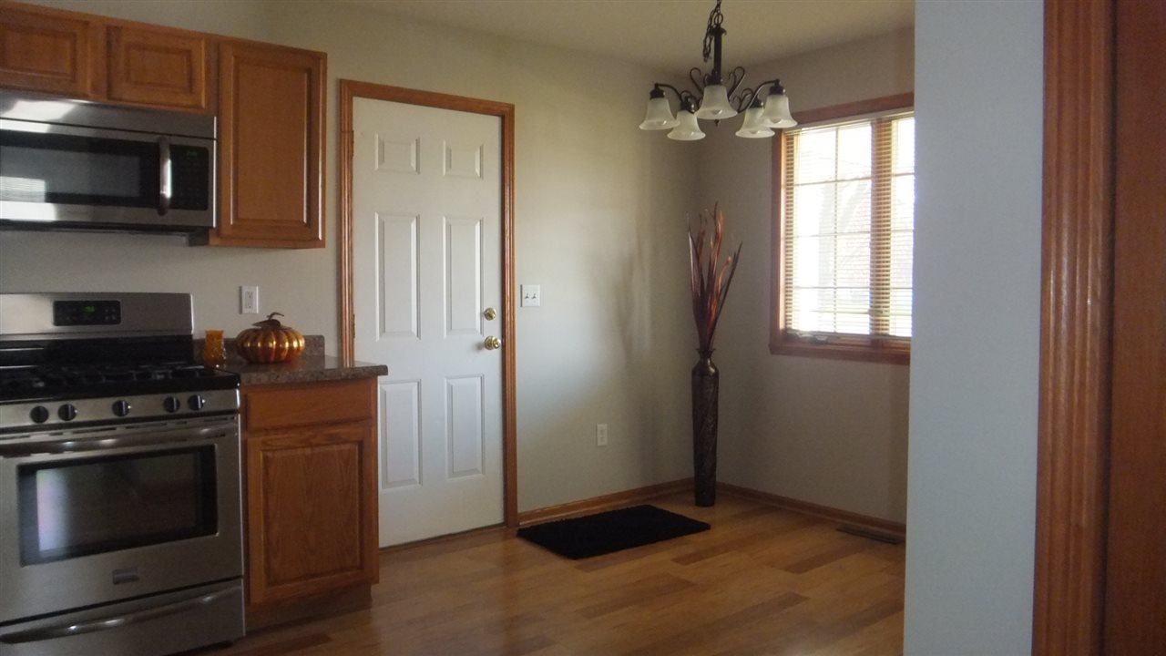 120 Minarette Drive Southwest Poplar Grove, IL 61065 - Photo 9 of 22 a kitchen with stainless steel appliances granite countertop a stove and a microwave