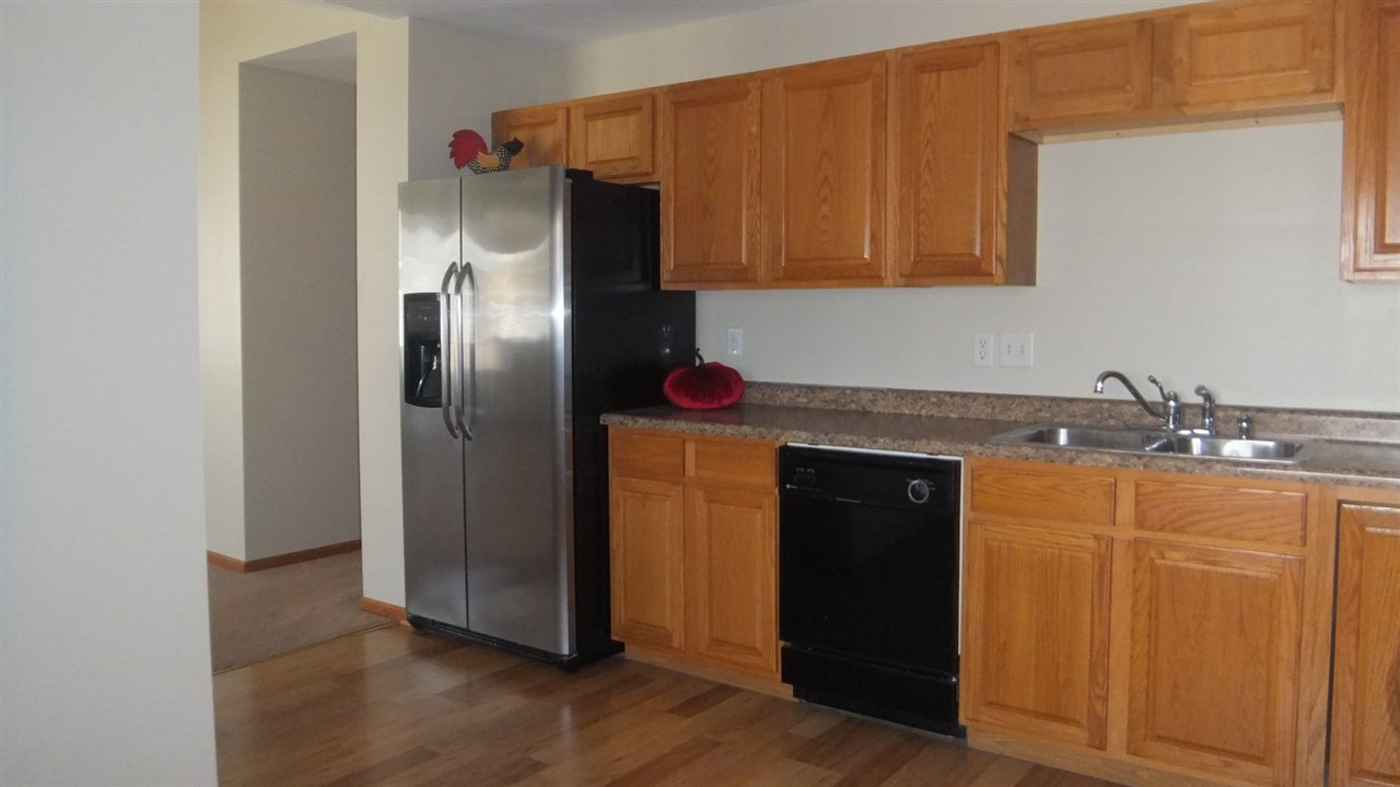 120 Minarette Drive Southwest Poplar Grove, IL 61065 - Photo 10 of 22 a kitchen with stainless steel appliances granite countertop a refrigerator and a sink