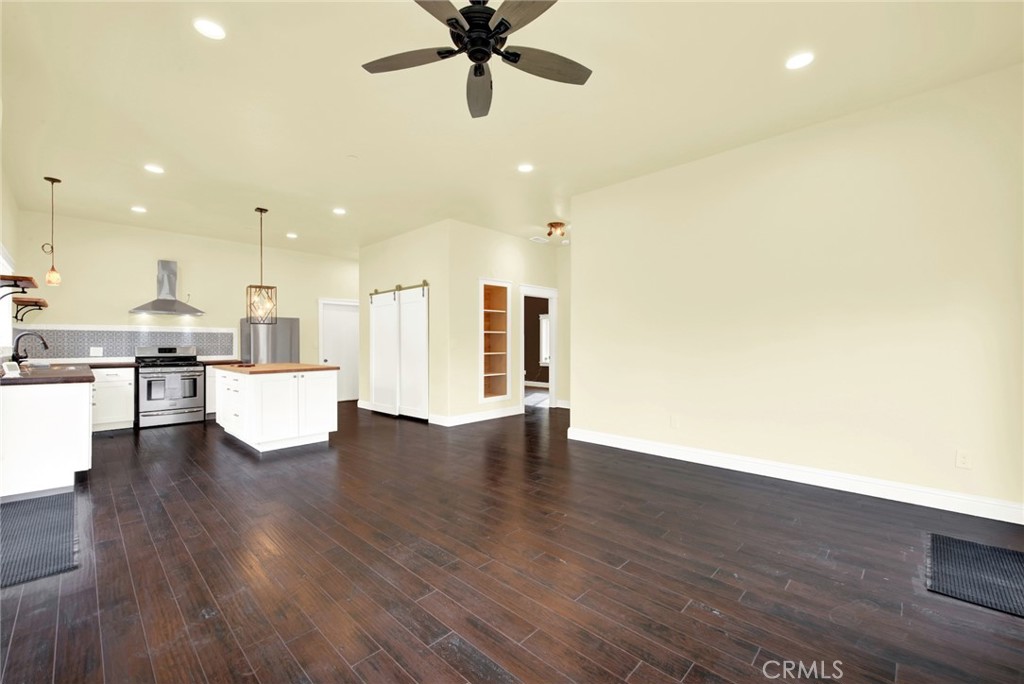 20506 Corning Road Corning, CA 96021 - Photo 14 of 53 a view of an empty room with wooden floor and a ceiling fan