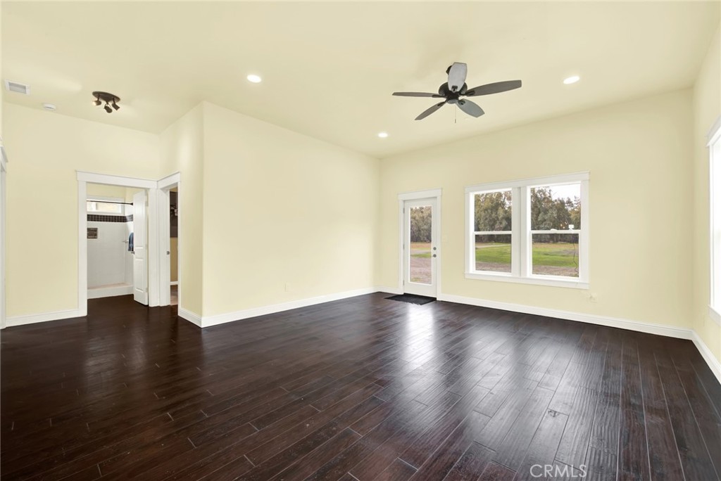 20506 Corning Road Corning, CA 96021 - Photo 16 of 53 a view of an empty room with wooden floor and a ceiling fan