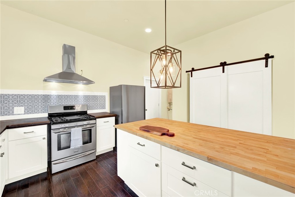20506 Corning Road Corning, CA 96021 - Photo 20 of 53 a kitchen with a stove a refrigerator and a table