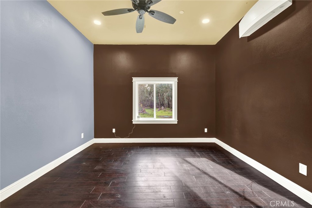 20506 Corning Road Corning, CA 96021 - Photo 27 of 53 an empty room with wooden floor and windows