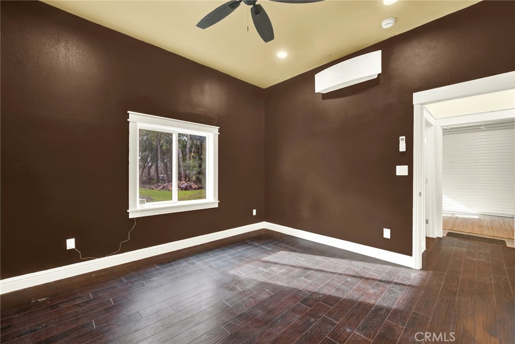 20506 Corning Road Corning, CA 96021 - Photo 28 of 53 an empty room with wooden floor and windows
