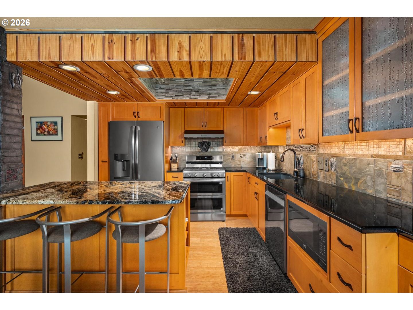 1840 Rees Hill Road Southeast, Unit 19 Salem, OR 97306 - Photo 11 of 34 a kitchen with stainless steel appliances kitchen island granite countertop a stove a sink and a refrigerator