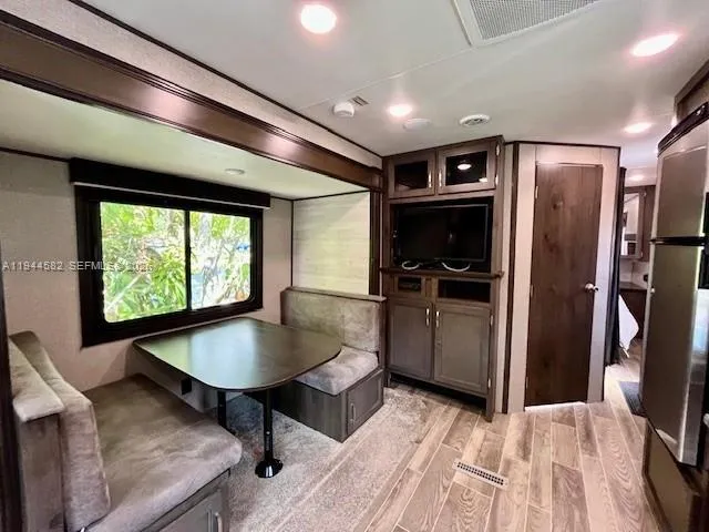 a kitchen with stainless steel appliances granite countertop a refrigerator a sink a stove and a refrigerator