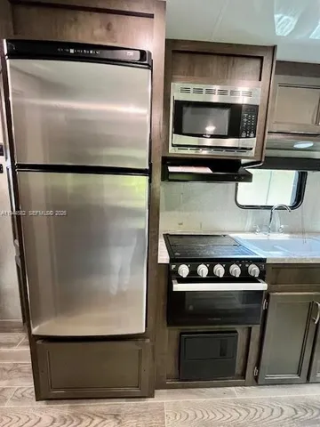 a kitchen with a refrigerator and a stove