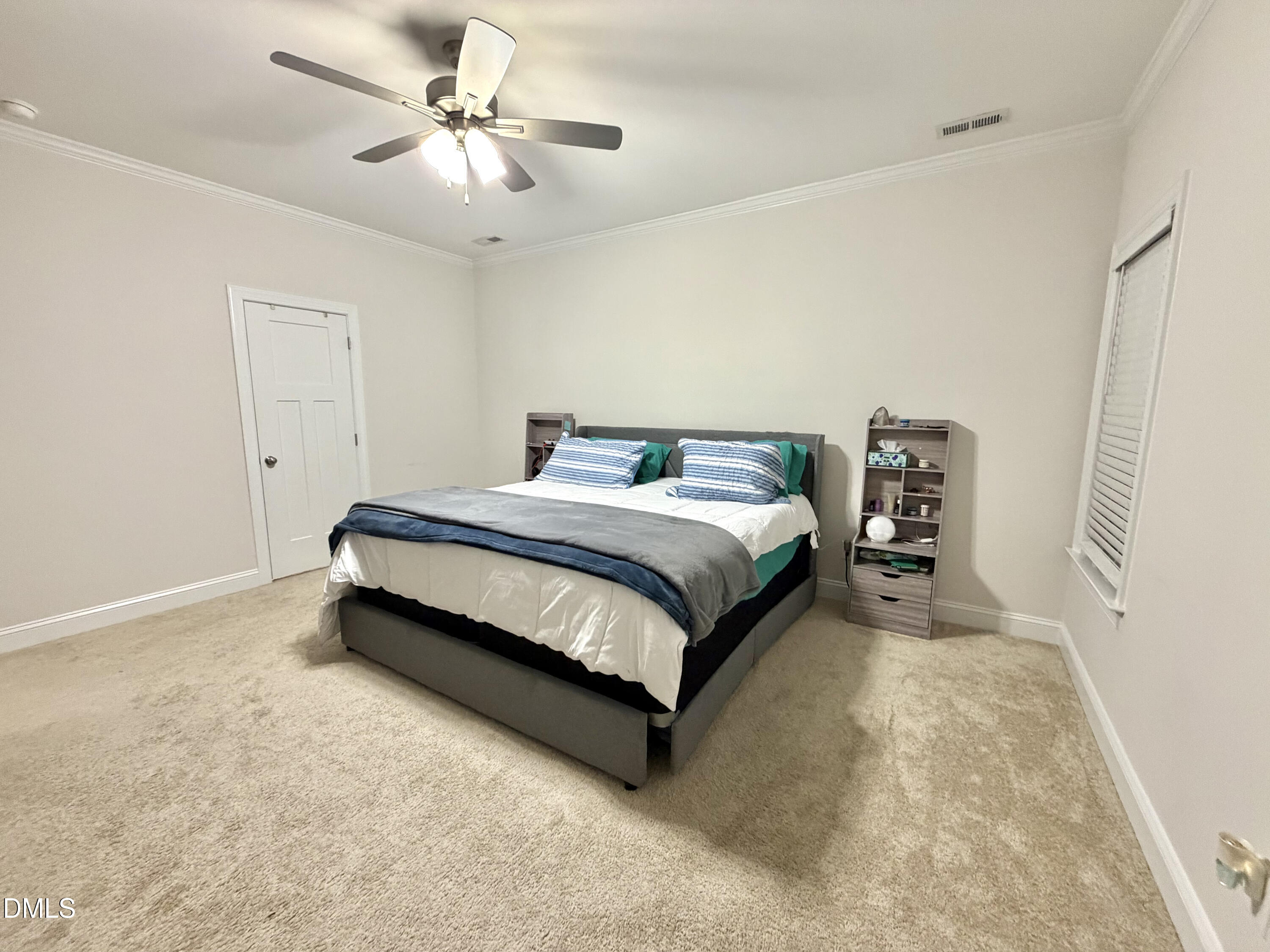 228 Ridgemoore Court Four Oaks, NC 27524 - Photo 16 of 30 a bedroom with a bed and a ceiling fan