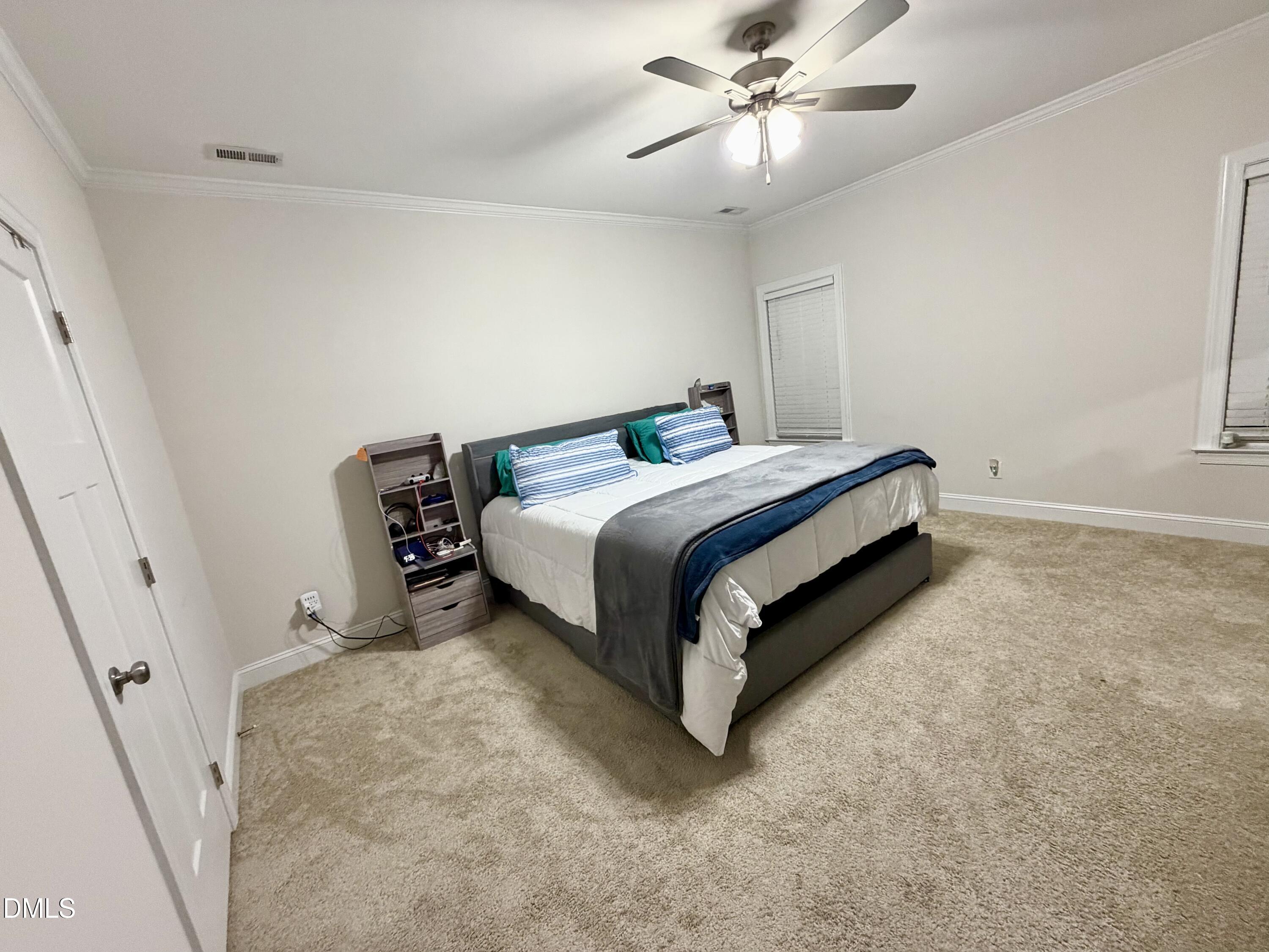 228 Ridgemoore Court Four Oaks, NC 27524 - Photo 17 of 30 a bed room with a bed and a ceiling fan