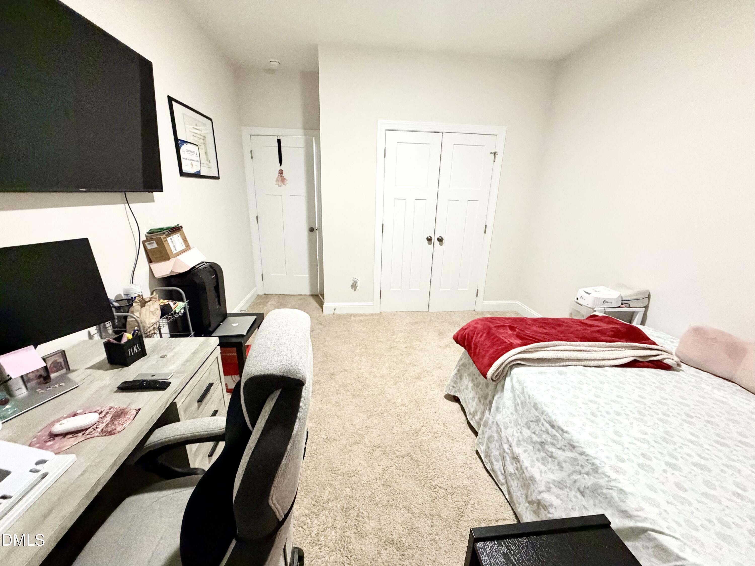228 Ridgemoore Court Four Oaks, NC 27524 - Photo 21 of 30 a bedroom with a bed and a flat screen tv