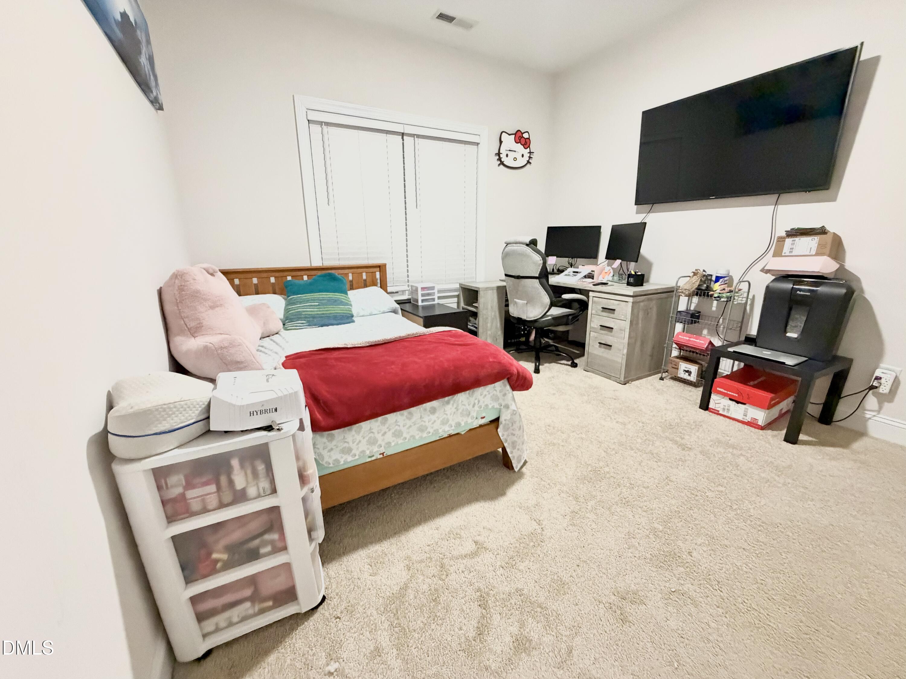228 Ridgemoore Court Four Oaks, NC 27524 - Photo 22 of 30 a bedroom with furniture and a flat screen tv