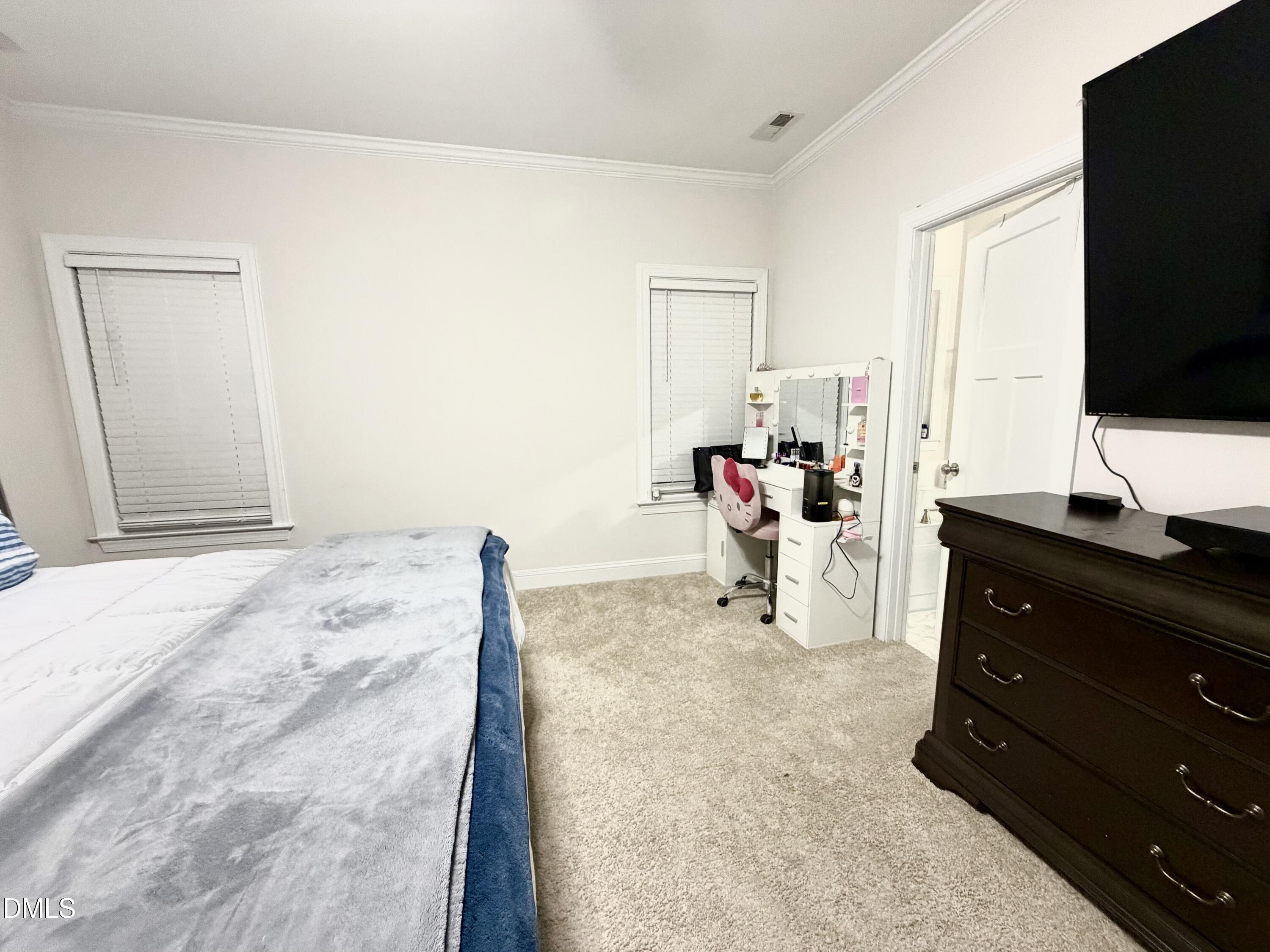 228 Ridgemoore Court Four Oaks, NC 27524 - Photo 23 of 30 a bed room with a bed and a television