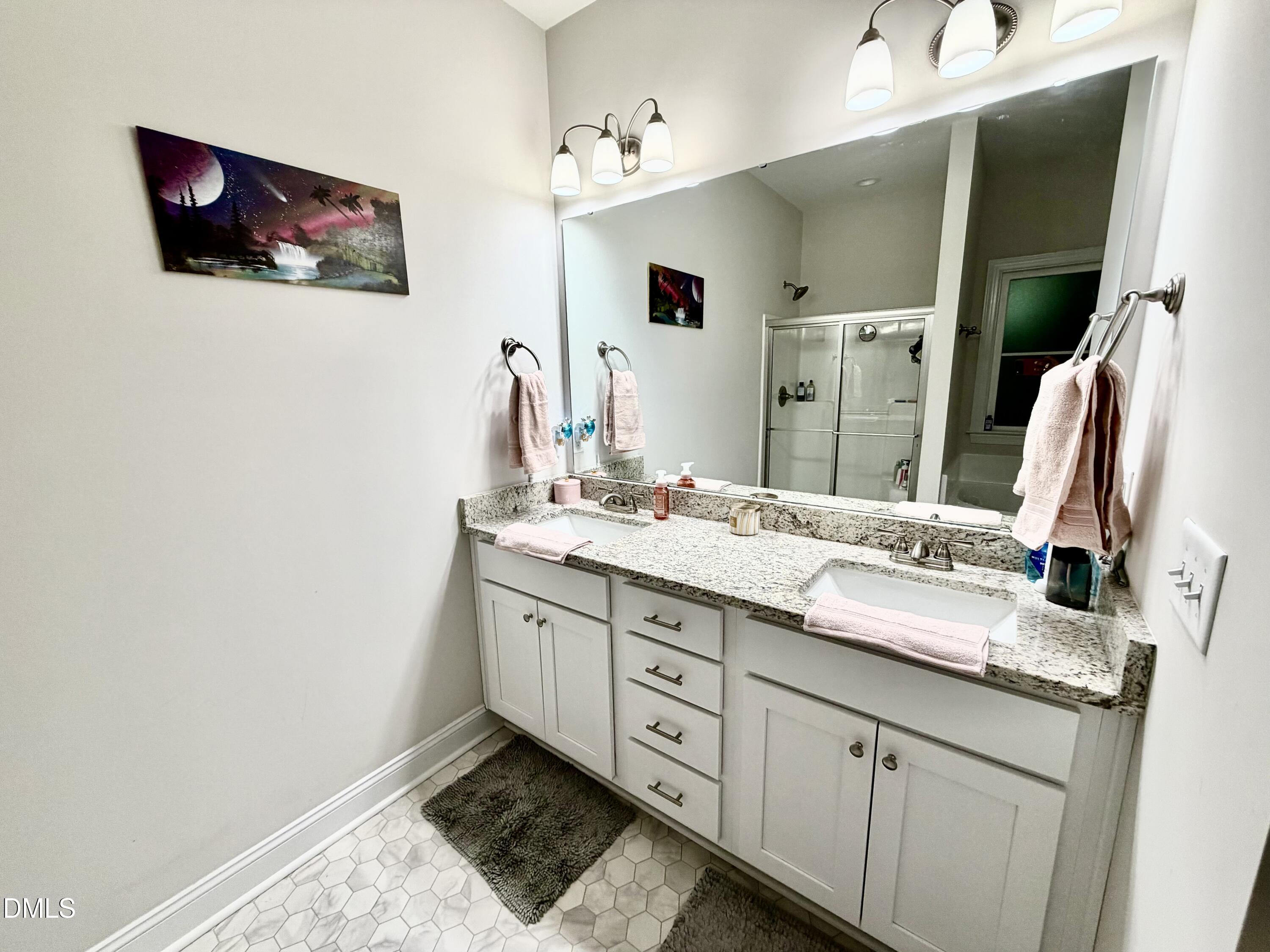 228 Ridgemoore Court Four Oaks, NC 27524 - Photo 9 of 30 a bathroom with a double vanity sink and a mirror