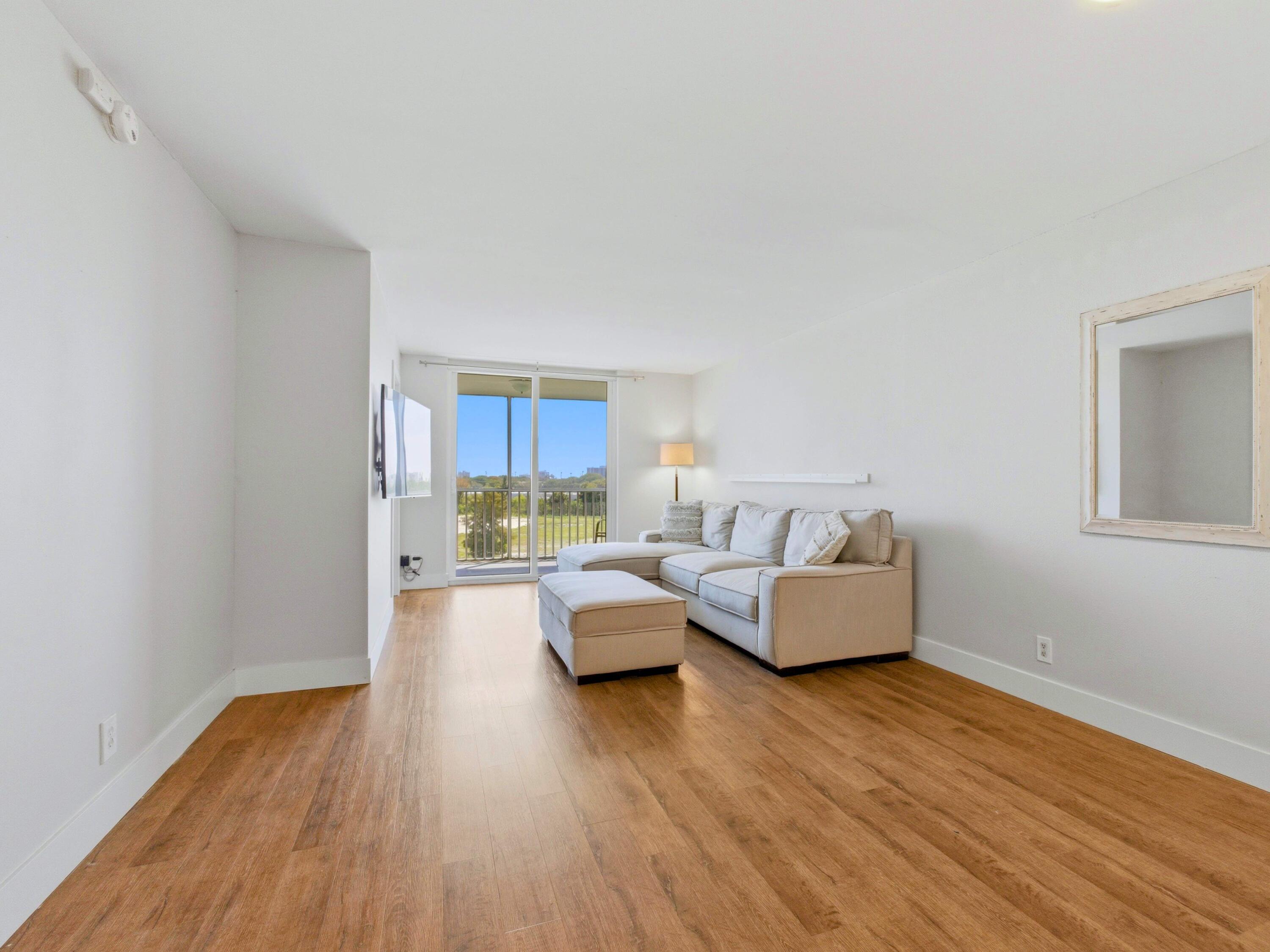 5500 Northwest 2nd Avenue, Unit 519 Boca Raton, FL 33487 - Photo 13 of 48 a living room with furniture and a wooden floor