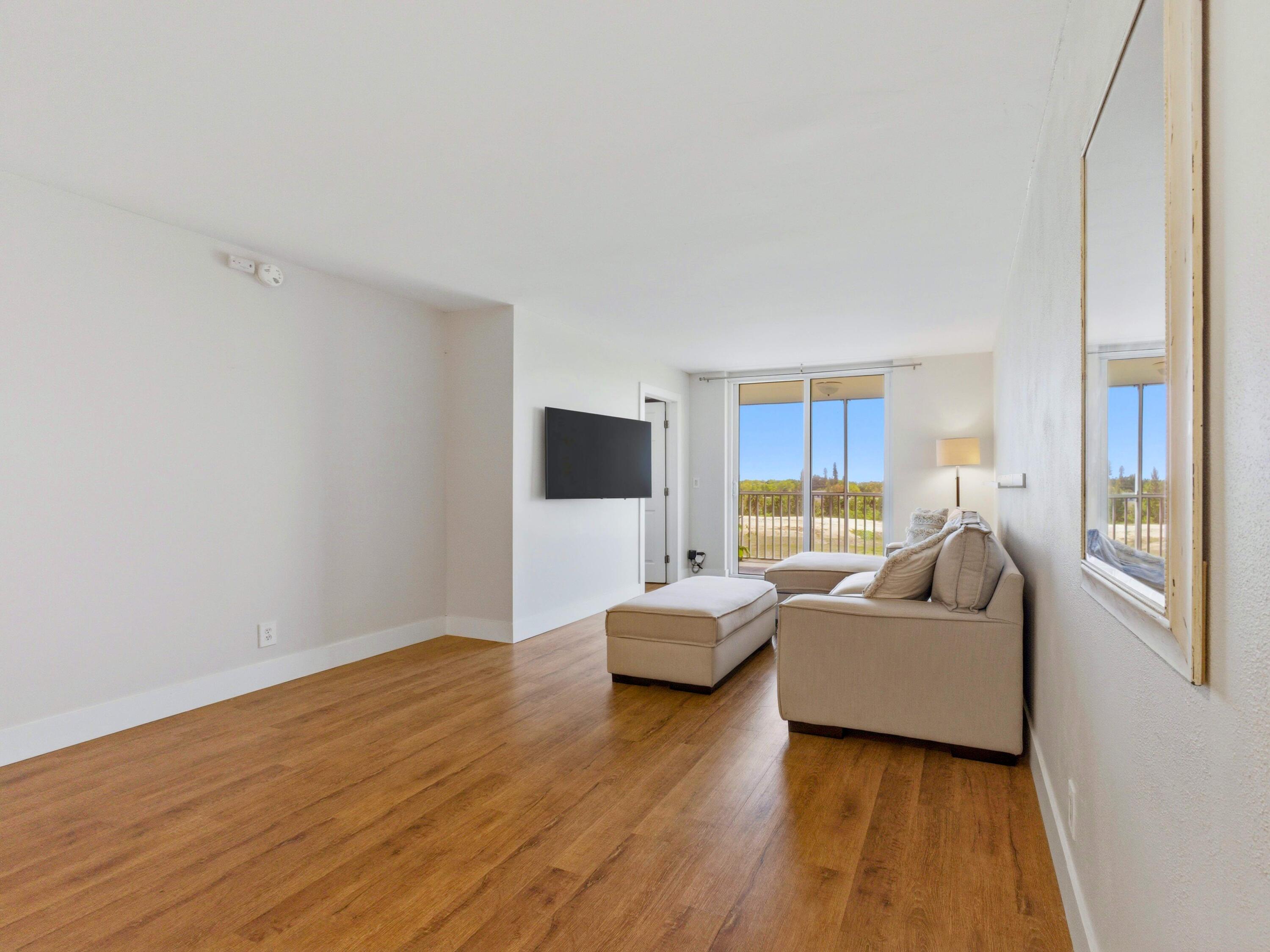 5500 Northwest 2nd Avenue, Unit 519 Boca Raton, FL 33487 - Photo 14 of 48 a living room with furniture and a flat screen tv
