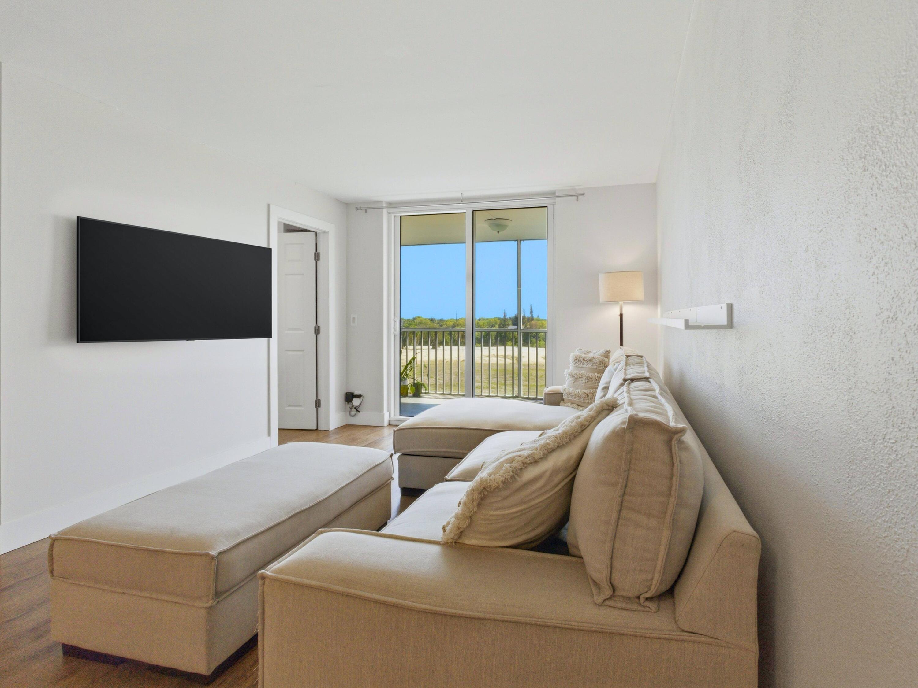 5500 Northwest 2nd Avenue, Unit 519 Boca Raton, FL 33487 - Photo 16 of 48 a living room with furniture and a flat screen tv