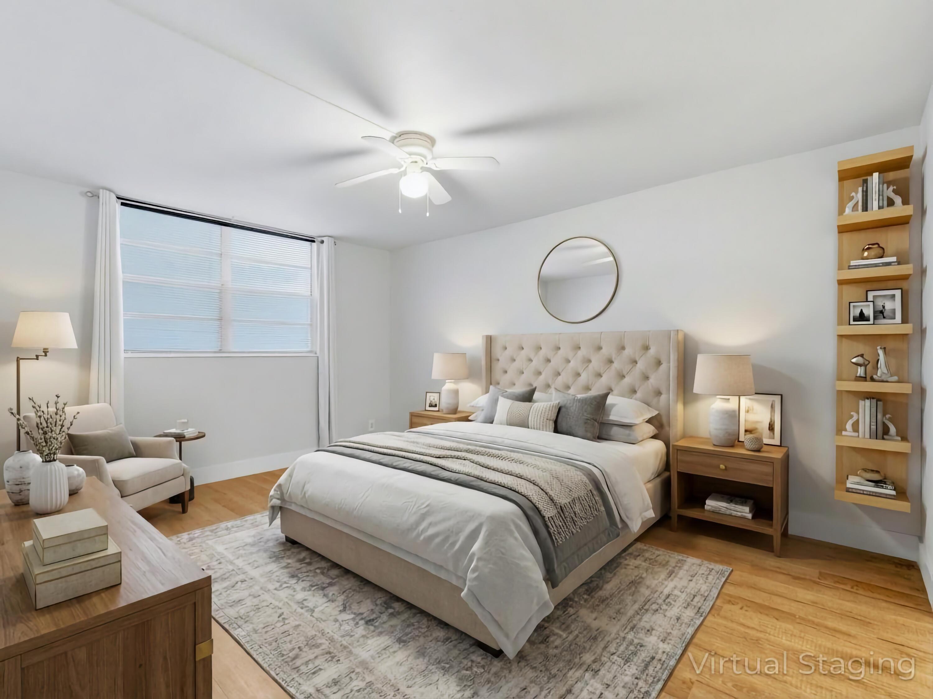 5500 Northwest 2nd Avenue, Unit 519 Boca Raton, FL 33487 - Photo 19 of 48 a bedroom with a large bed and a chandelier