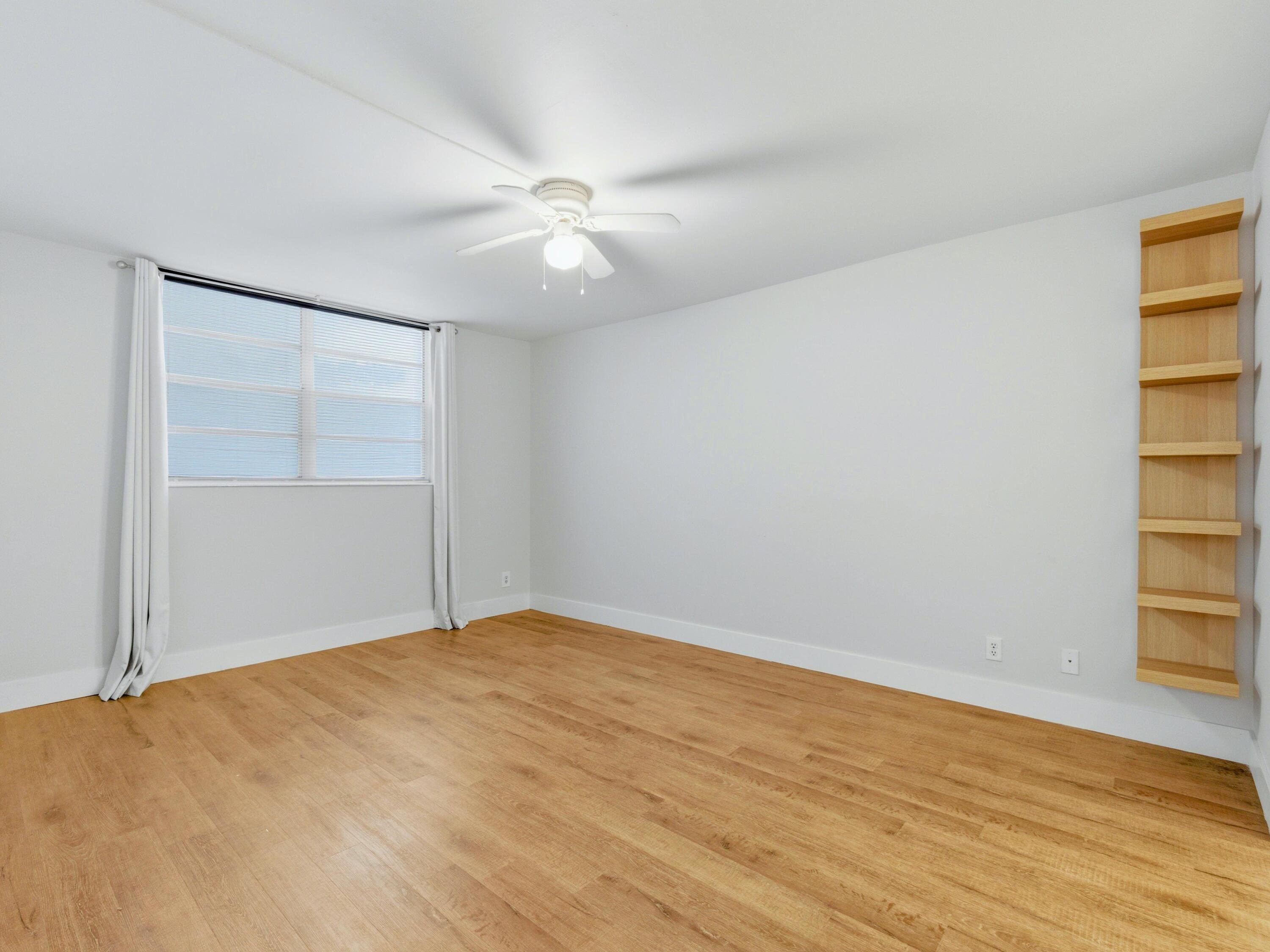 5500 Northwest 2nd Avenue, Unit 519 Boca Raton, FL 33487 - Photo 20 of 48 a view of empty room with wooden floor and fan