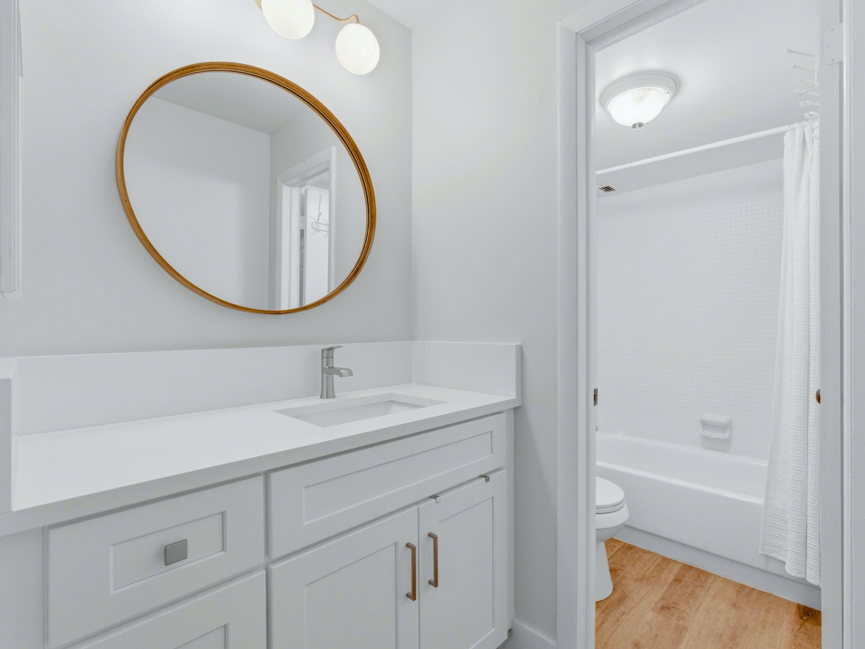 5500 Northwest 2nd Avenue, Unit 519 Boca Raton, FL 33487 - Photo 22 of 48 a bathroom with a sink a toilet and a mirror