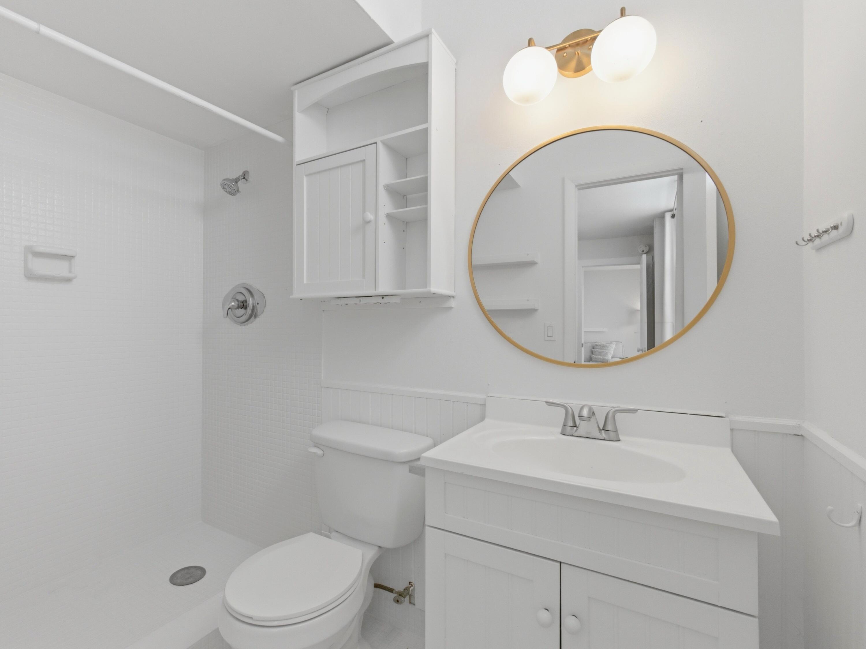 5500 Northwest 2nd Avenue, Unit 519 Boca Raton, FL 33487 - Photo 26 of 48 a bathroom with a sink a toilet and a mirror