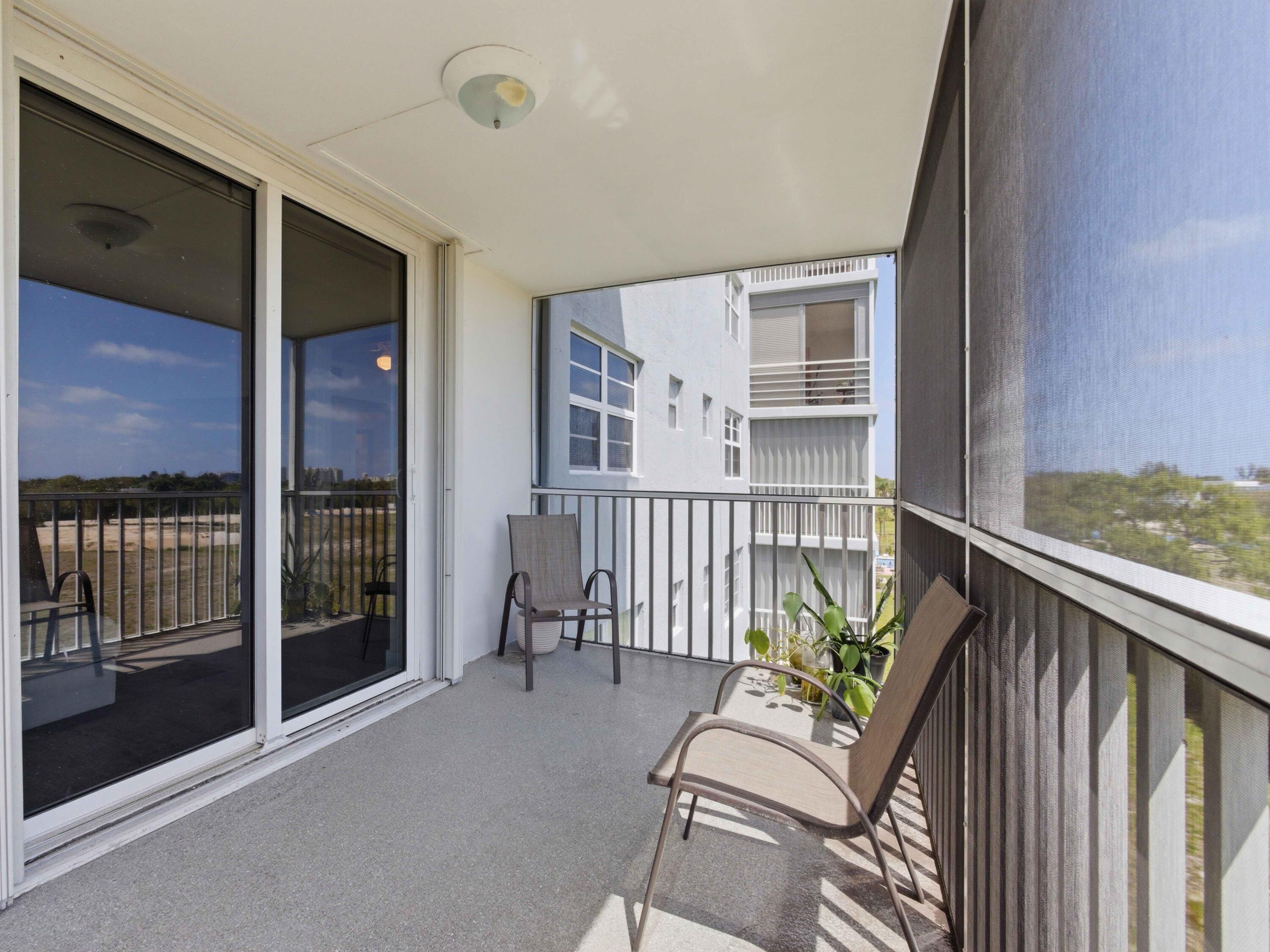 5500 Northwest 2nd Avenue, Unit 519 Boca Raton, FL 33487 - Photo 28 of 48 a balcony with furniture and a potted plant