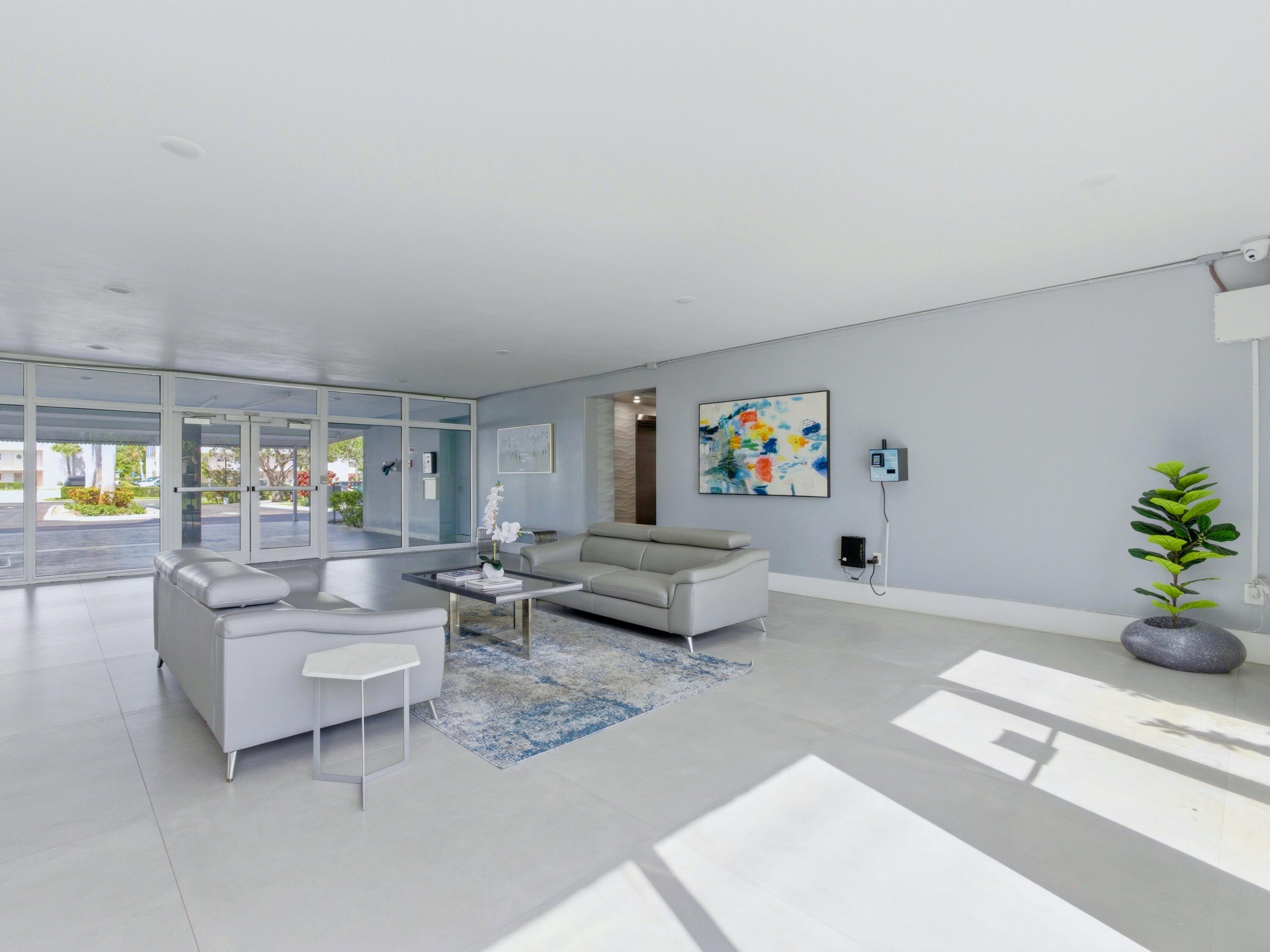 5500 Northwest 2nd Avenue, Unit 519 Boca Raton, FL 33487 - Photo 33 of 48 a living room with furniture and flowers