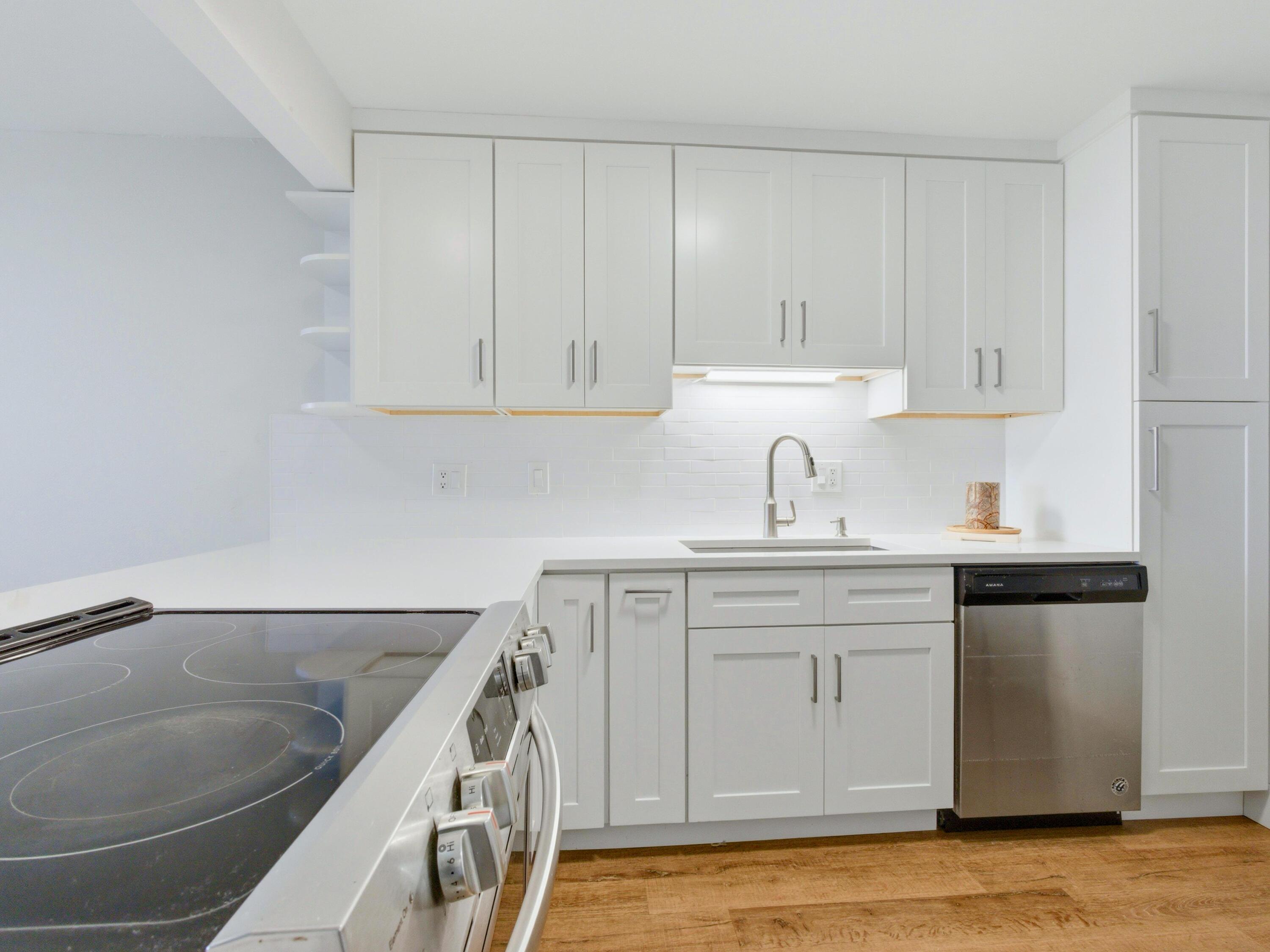 5500 Northwest 2nd Avenue, Unit 519 Boca Raton, FL 33487 - Photo 5 of 48 a kitchen with white cabinets sink and stove