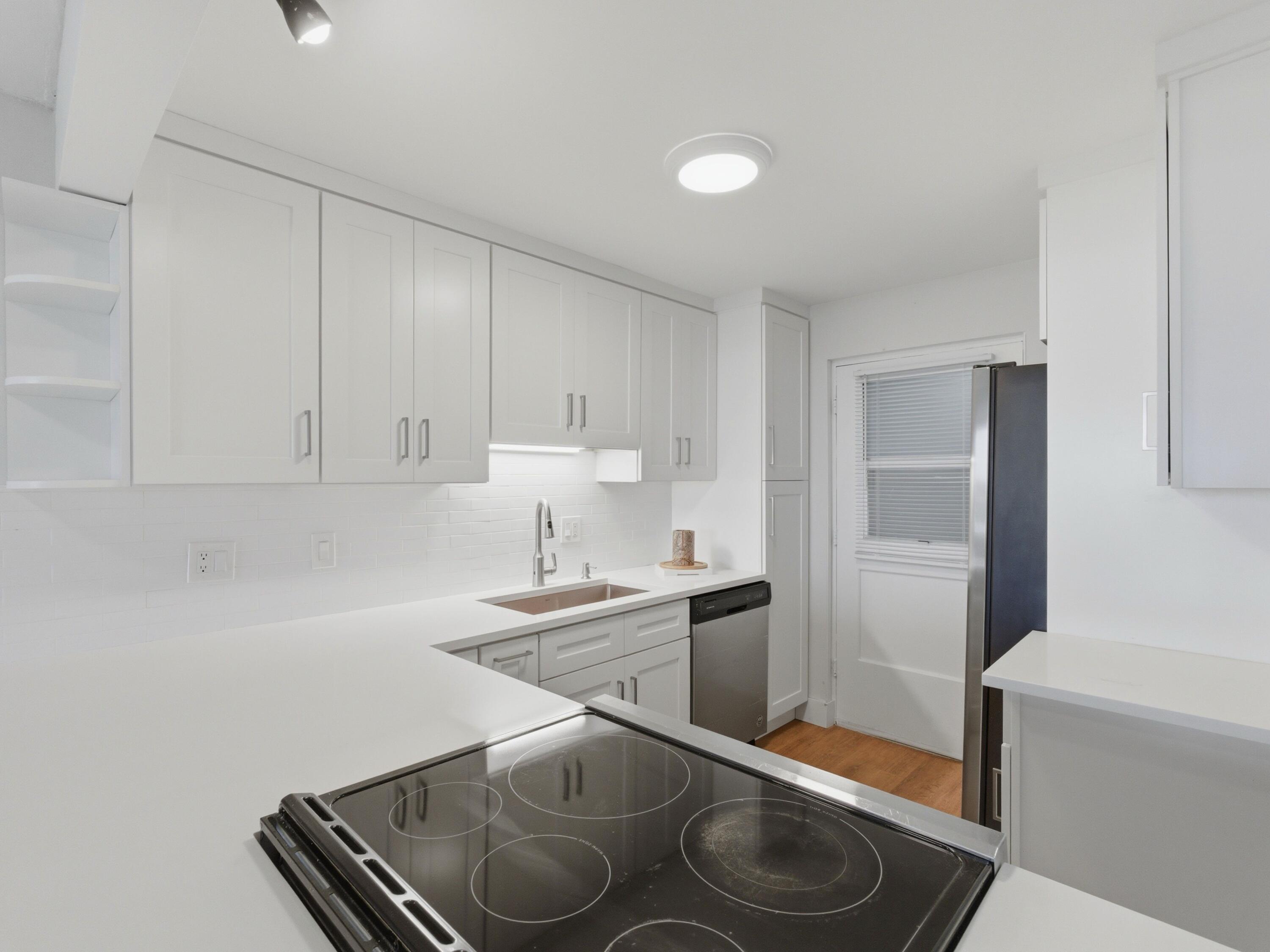 5500 Northwest 2nd Avenue, Unit 519 Boca Raton, FL 33487 - Photo 6 of 48 a kitchen with stainless steel appliances granite countertop a sink stove and cabinets