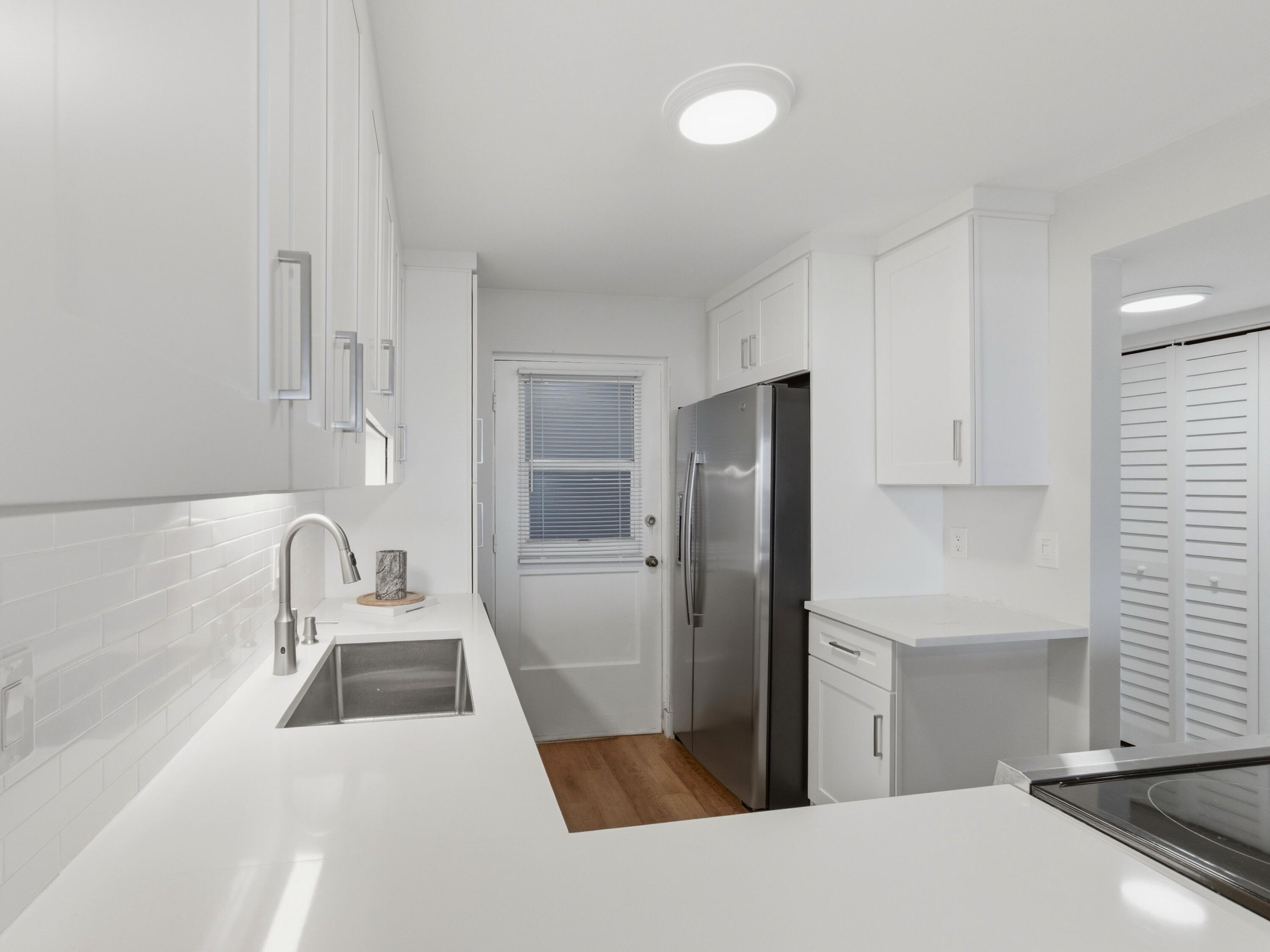 5500 Northwest 2nd Avenue, Unit 519 Boca Raton, FL 33487 - Photo 7 of 48 a kitchen with a refrigerator and a sink