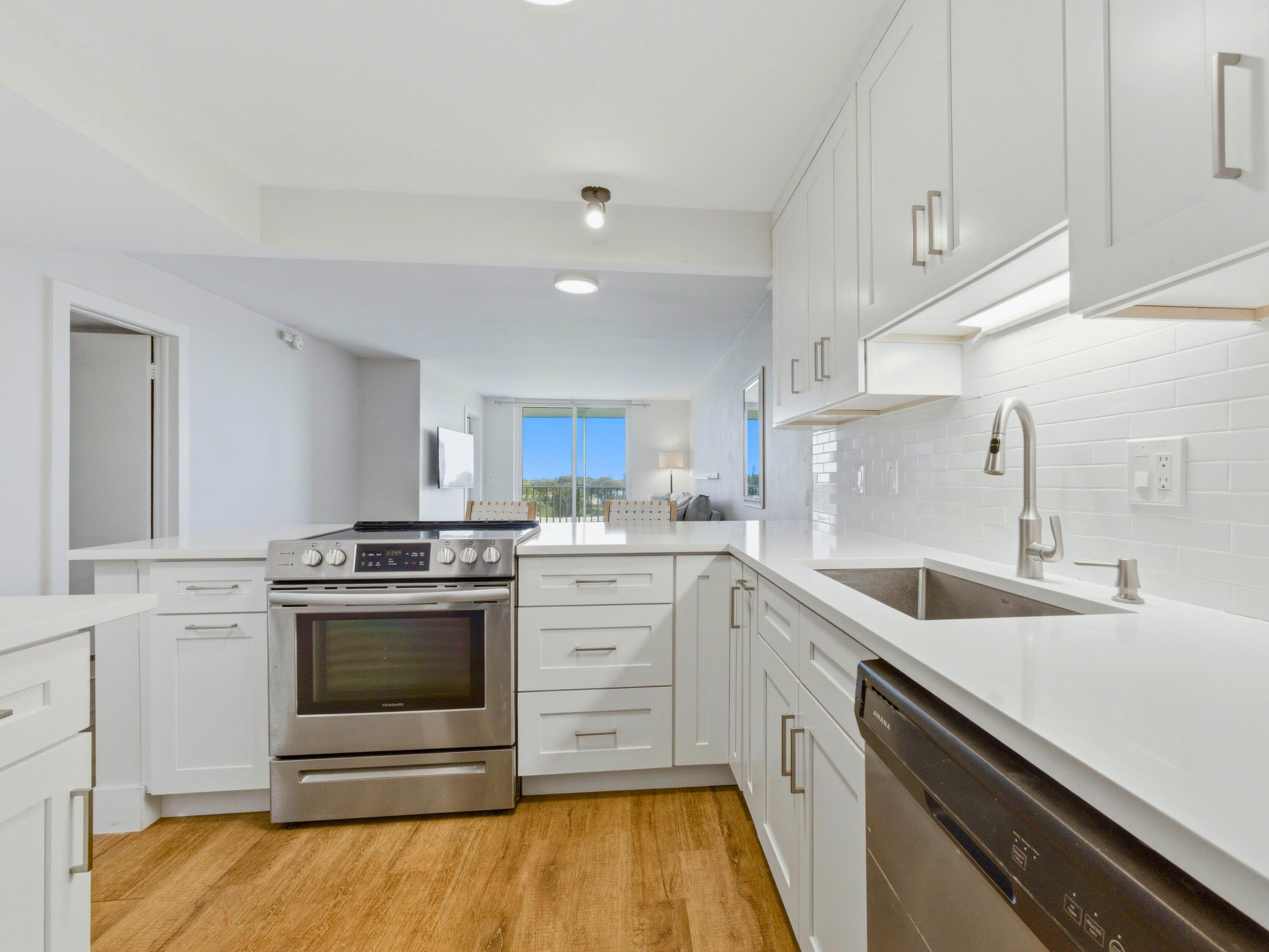 5500 Northwest 2nd Avenue, Unit 519 Boca Raton, FL 33487 - Photo 8 of 48 a kitchen with a sink stove and cabinets