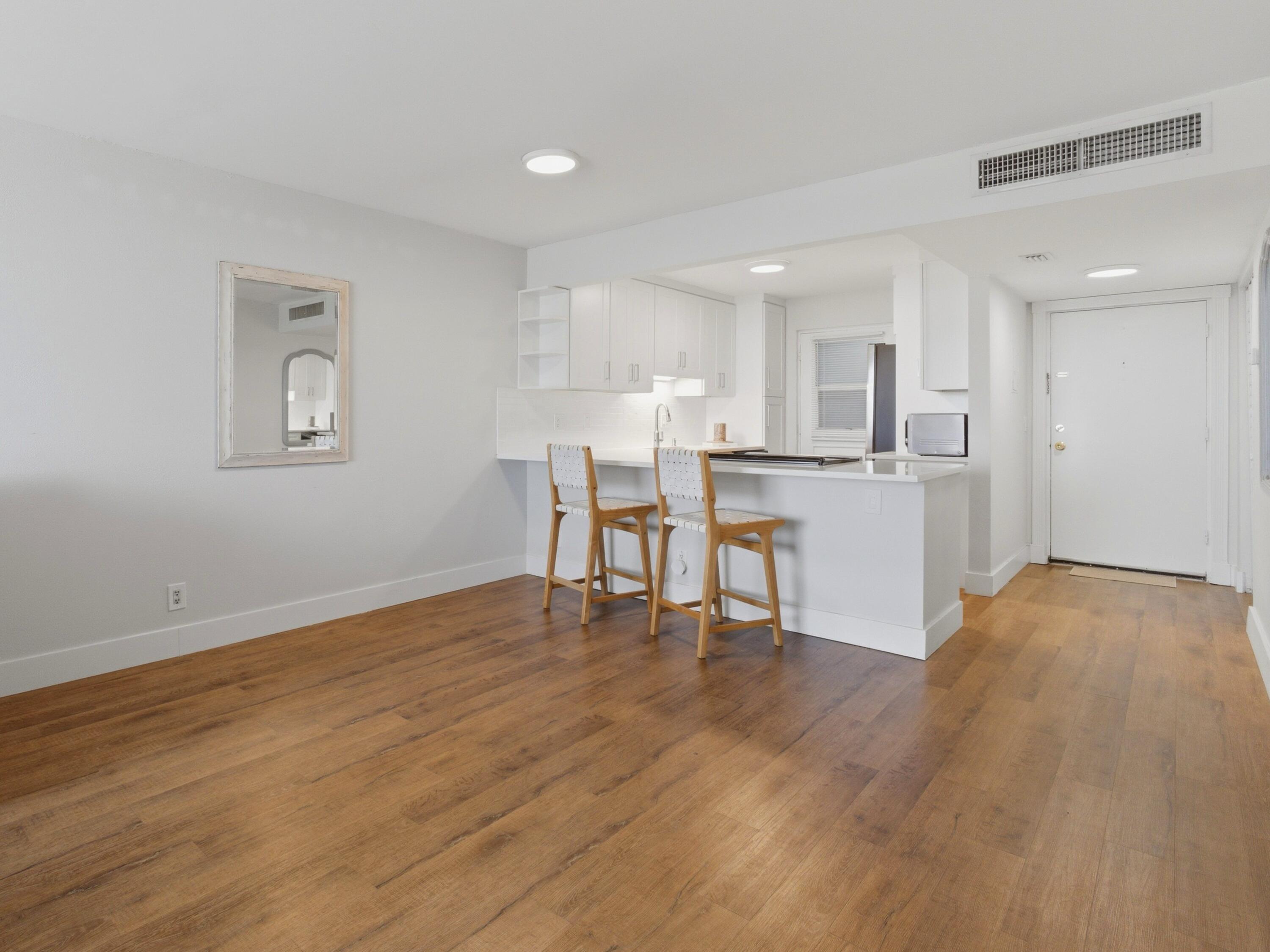 5500 Northwest 2nd Avenue, Unit 519 Boca Raton, FL 33487 - Photo 9 of 48 a view of kitchen with cabinets and wooden floor