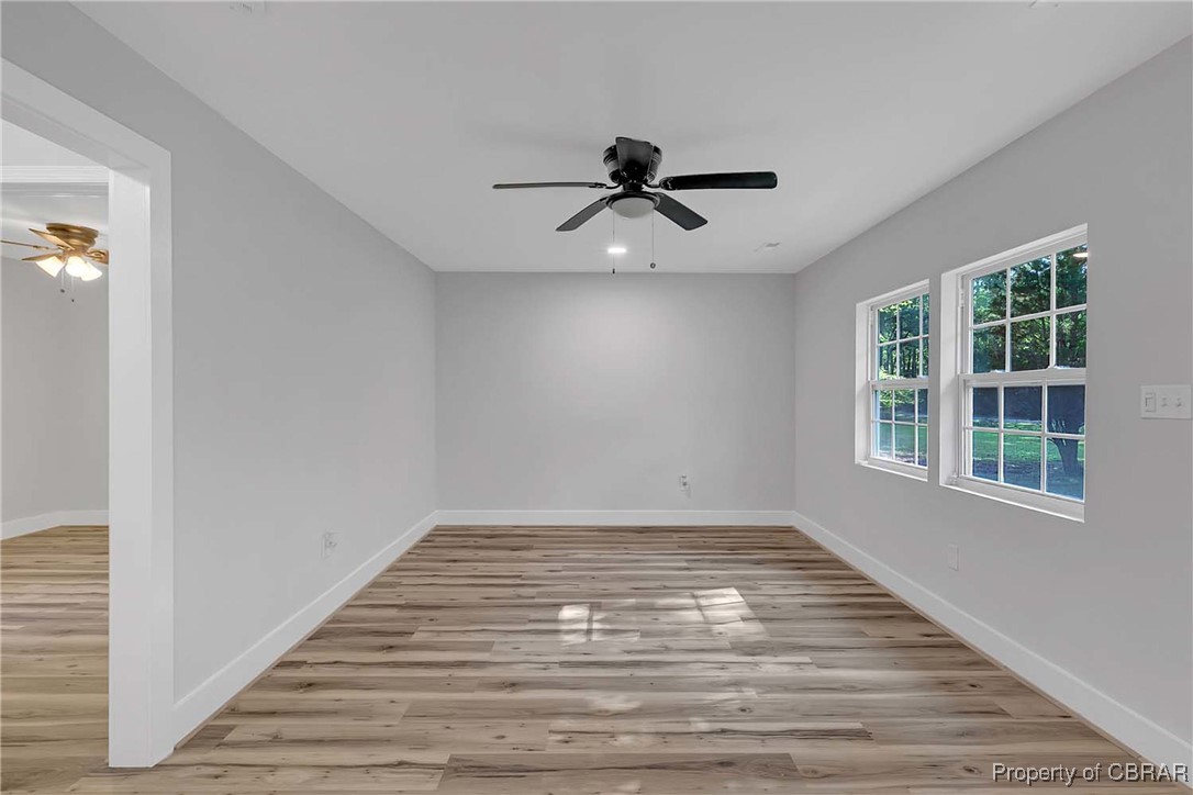 830 Glebe Road Mathews, VA 23109 - Photo 8 of 17 a view of empty room with wooden floor and fan