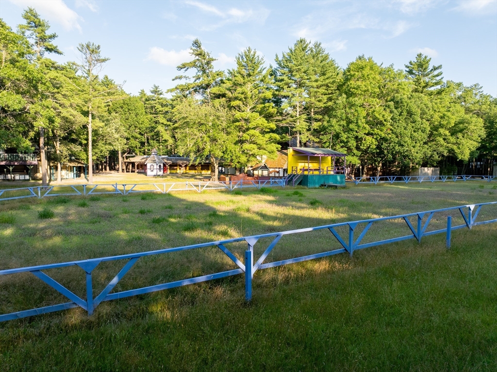 235 South Main Street Carver, MA 02330 - Photo 6 of 34 a view of a swimming pool with a bench and trees