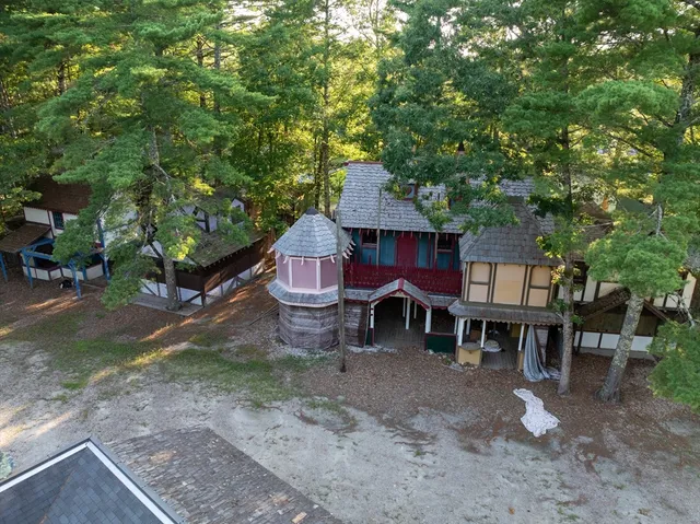 a backyard of a house with table and chairs